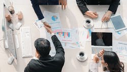 1660317240718 Fourbusinesspeoplemakingagreementovertablewithpapersfeaturingdatacharts 1660317240718 Fourbusinesspeoplemakingagreementovertablewithpapersfeaturingdatacharts