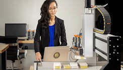 female-engineer-on-a-computer-near-a-robot