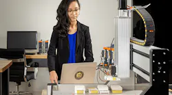 female-engineer-on-a-computer-near-a-robot