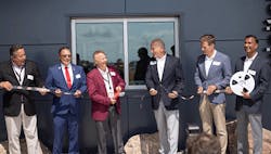 Photo-of-Chris-Lauer-Brian-Holmer-Rob-Stordahl-Dave-Doherty-Steve-Grove-and-Ramesh-Babu-cutting-digi-reel-in-front-of-new-distribution-center-building Photo-of-Chris-Lauer-Brian-Holmer-Rob-Stordahl-Dave-Doherty-Steve-Grove-and-Ramesh-Babu-cutting-digi-reel-in-front-of-new-distribution-center-building