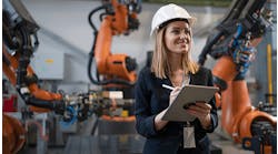 photo-of-female-engineer-in-front-of-robotic-arms