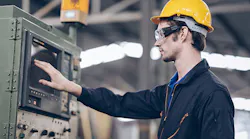 engineer-controls-machine-to-automated-CNC-in-factory