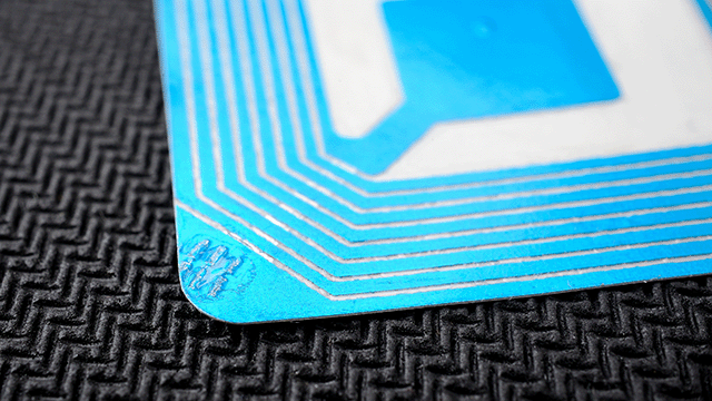 Stock image of blue RFID tag on black background
