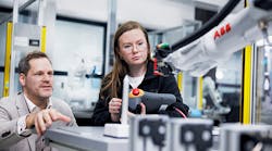 mentor and student watching ABB robotic arm mentor and student watching ABB robotic arm