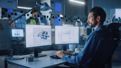 Industrial Engineer Solving Problems, Working on a Personal Computer, Two Monitor Screens Show CAD Software Industrial Engineer Solving Problems, Working on a Personal Computer, Two Monitor Screens Show CAD Software