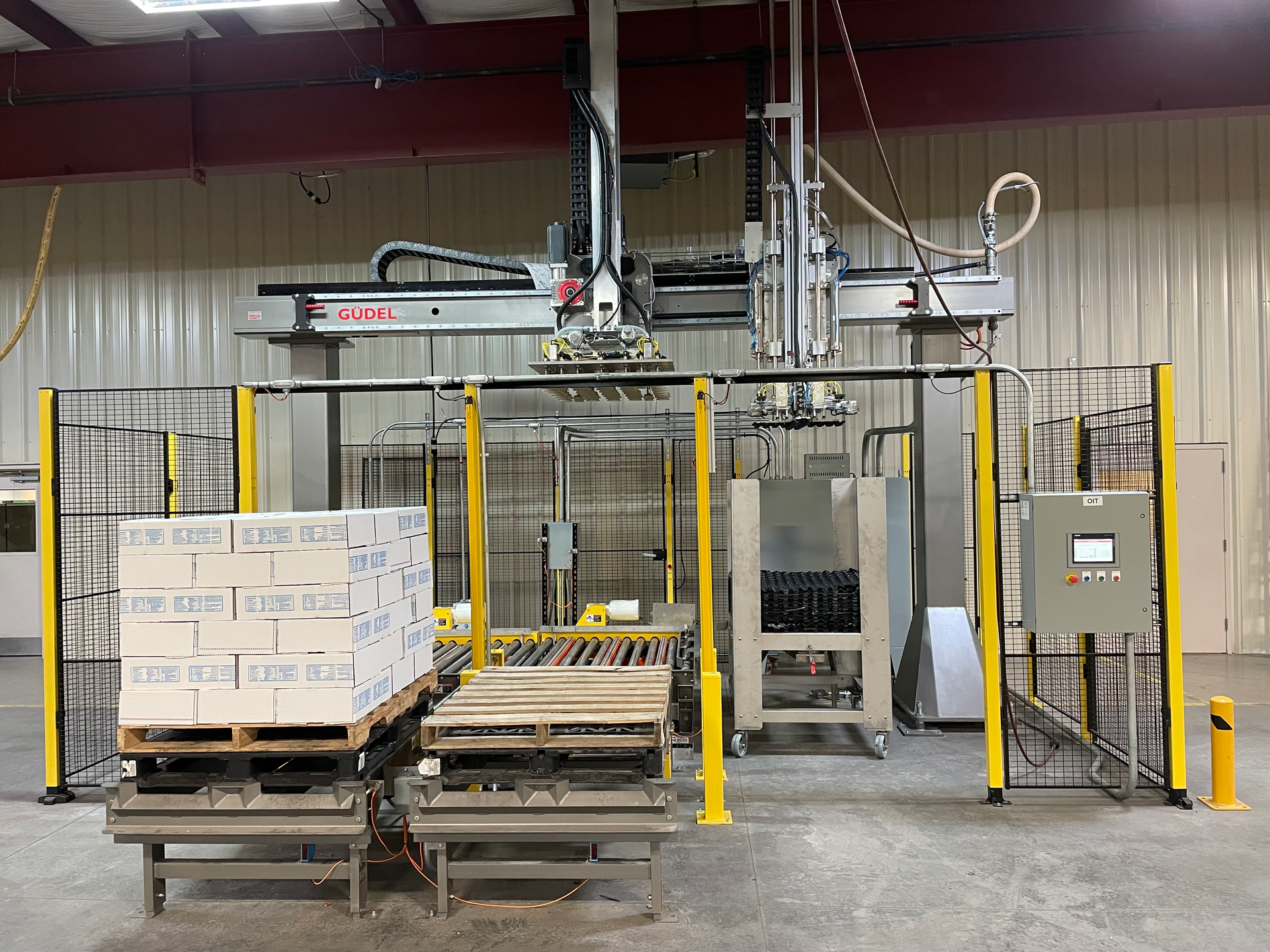 Figure 1: The gantry palletizer is a system designed for poultry processors so they can stack boxes of frozen chicken separated by special dunnage that allows air flow through the stacked boxes to assure the meat in the center of the pallet will be frozen completely. It is being marketed and sold as a pre-engineered system.