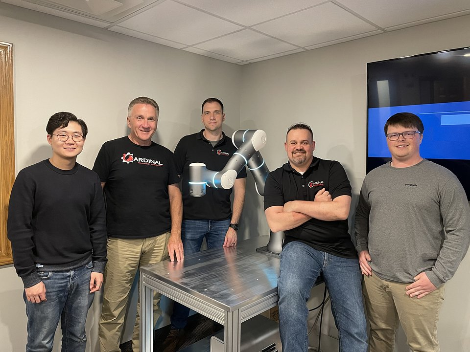 Flexiv Robotics Application Engineer Dajun Tao (left) meets the Cardinal Machine team.