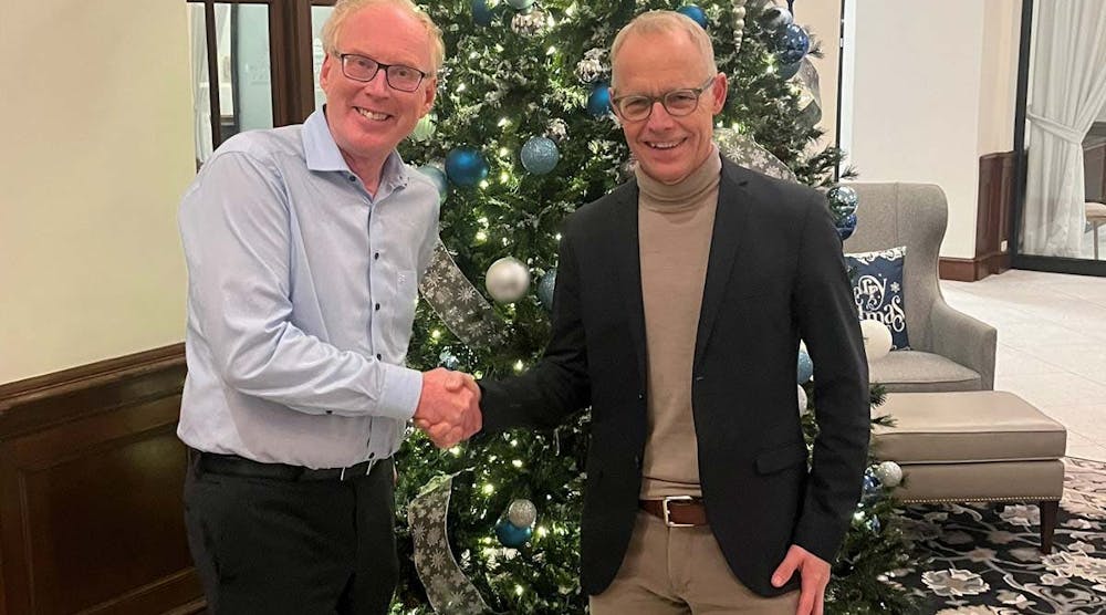 Marcel van Helten, CEO, Red Lion Controls, and Staffan Dahlstr&ouml;m, CEO, HMS Networks, shake hands after signing.
