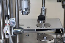 Figure 1: TurboFil’s Acrobat Chuck Capper features a two-chuck system with a chasing chuck that automatically locates the next bottle along the belt. Figure 1: TurboFil’s Acrobat Chuck Capper features a two-chuck system with a chasing chuck that automatically locates the next bottle along the belt.