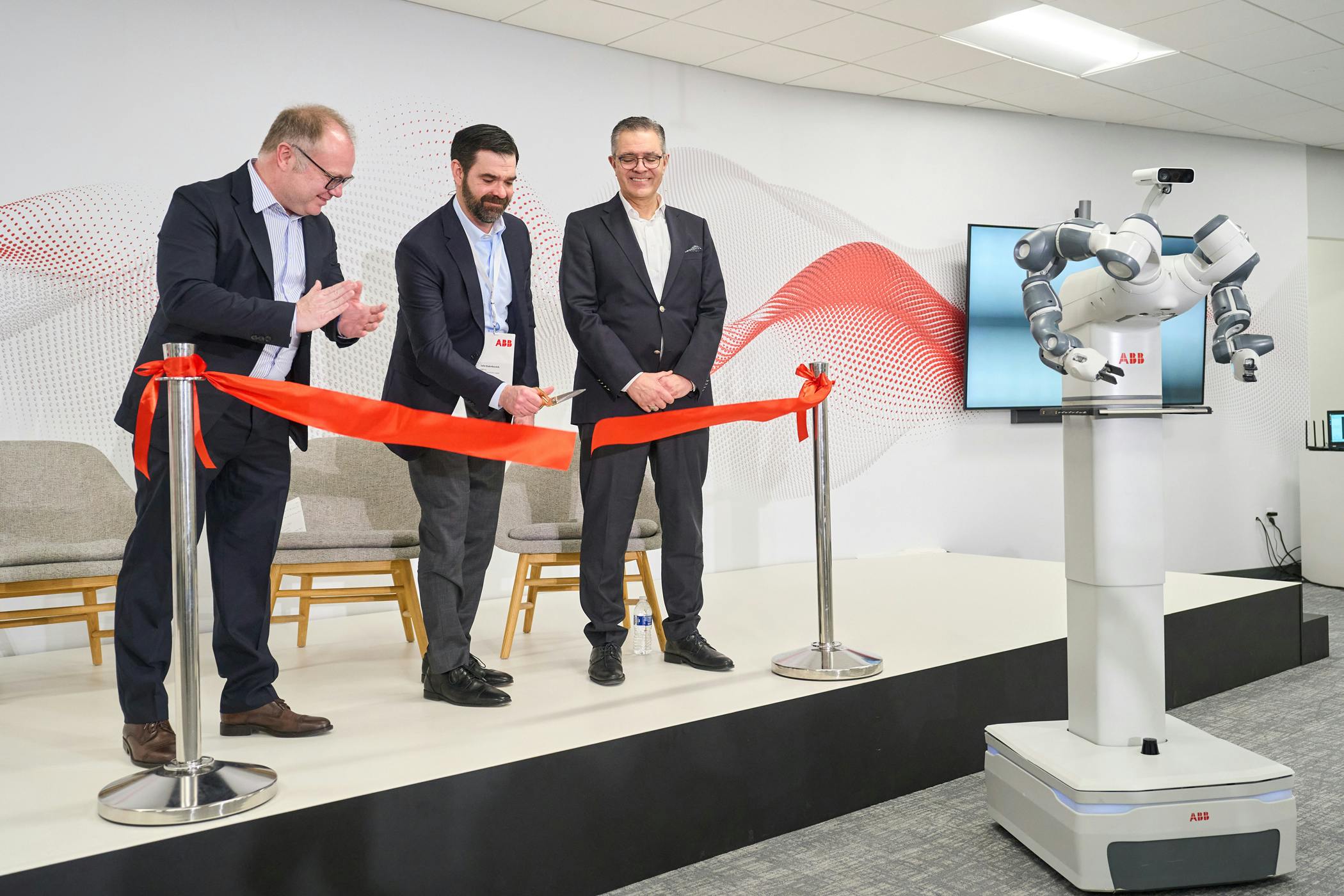 ABB's Marc Segura, John Bubnikovich and Sami Atiya cut the ribbon on ABB Robotics renovated facility.