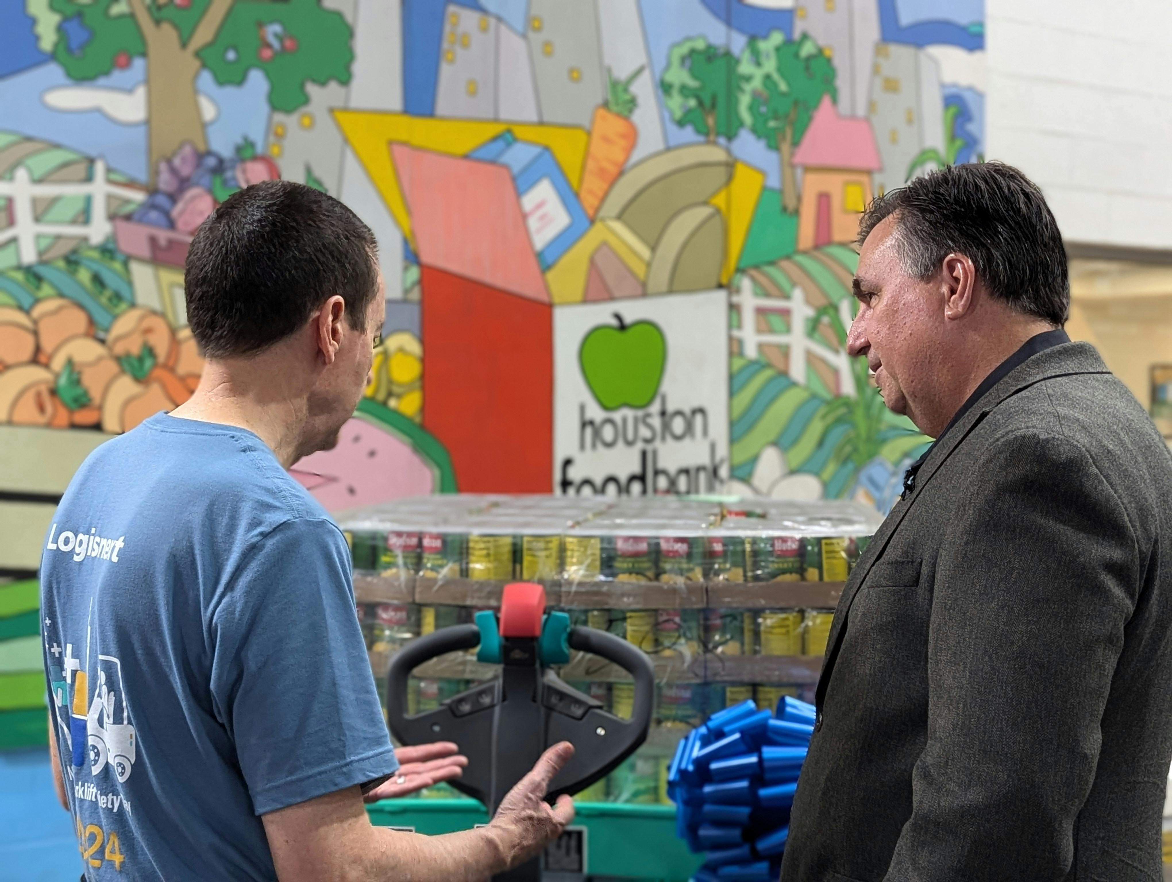 Mitsubishi Logisnext President Ken Barina (left) and Houston Food Bank President/CEO Brian Greene brought their organizations together to help feed people.