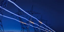 High-voltage electric transmission tower with glowing current line High-voltage electric transmission tower with glowing current line