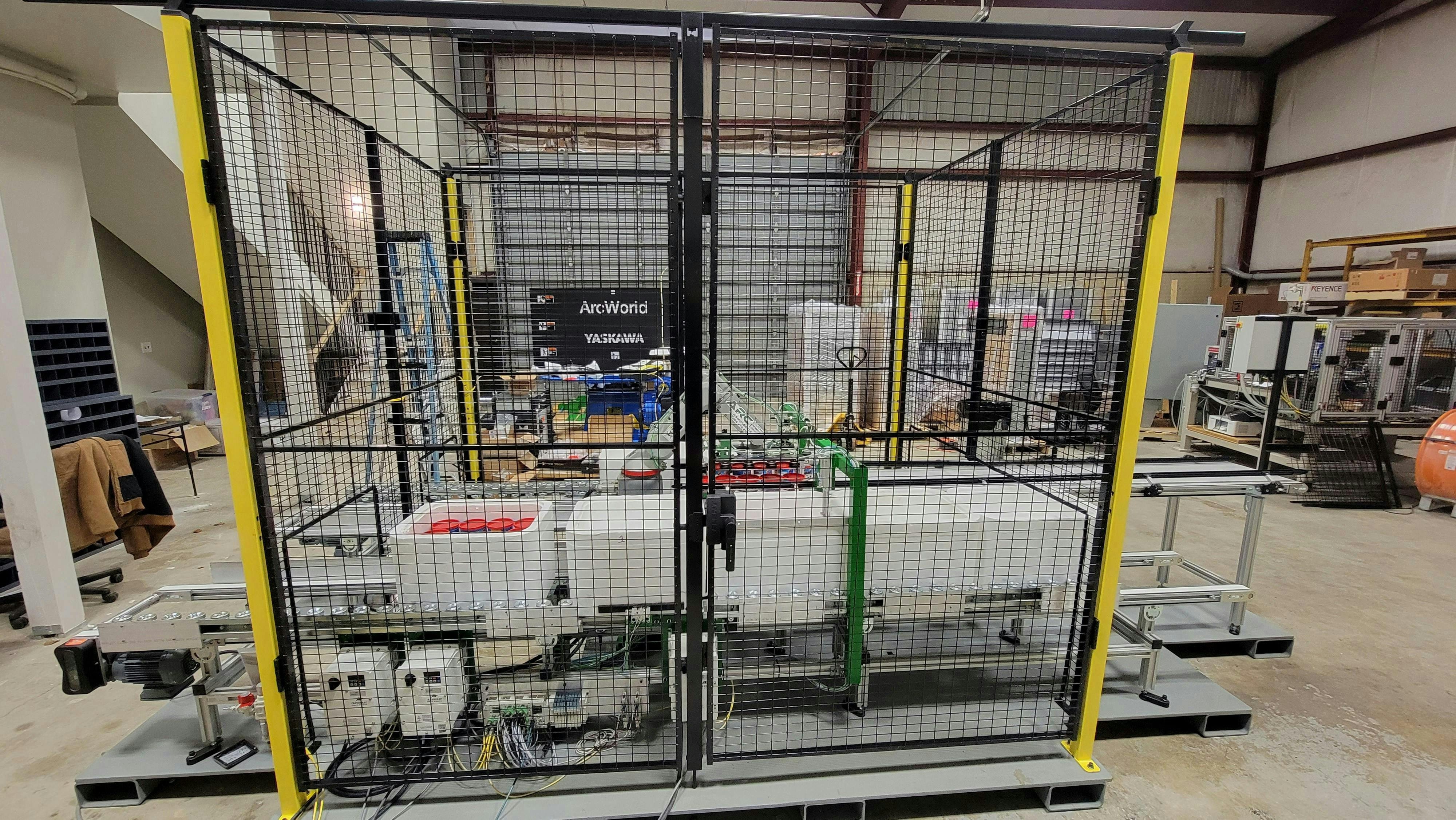 Figure 1: ARC designed a system with an industrial robot to pick and place worm containers into a cooler for a bait manufacturer.