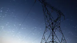 Screen with times against the evening electricity pylon silhouette