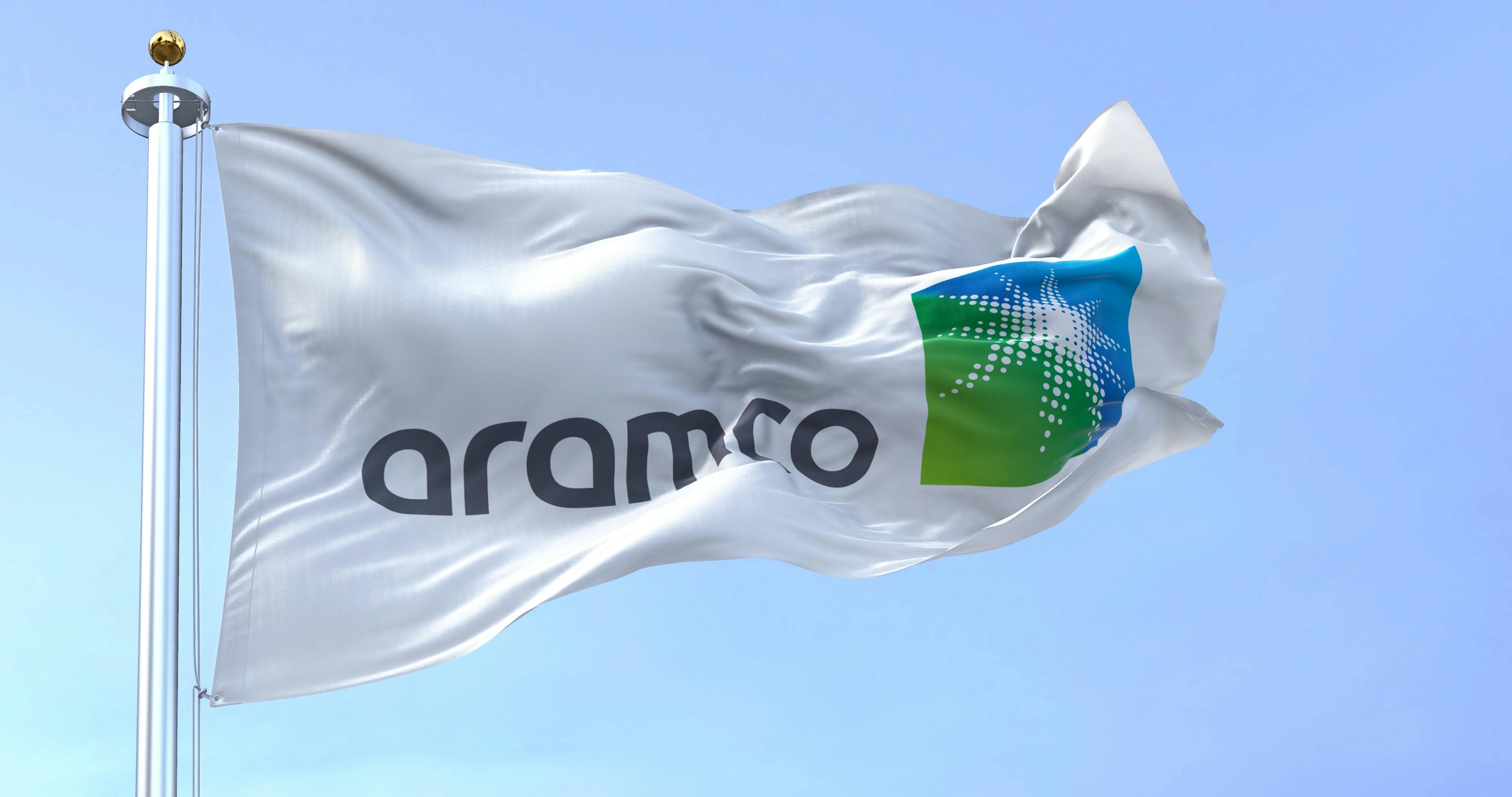 The flag of the Aramco oil company waving in the wind