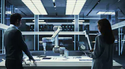Young Female Engineer Works with Colleague Scientist. They Collaborate on a Robot Arm Development, Research and Manufacture Project.