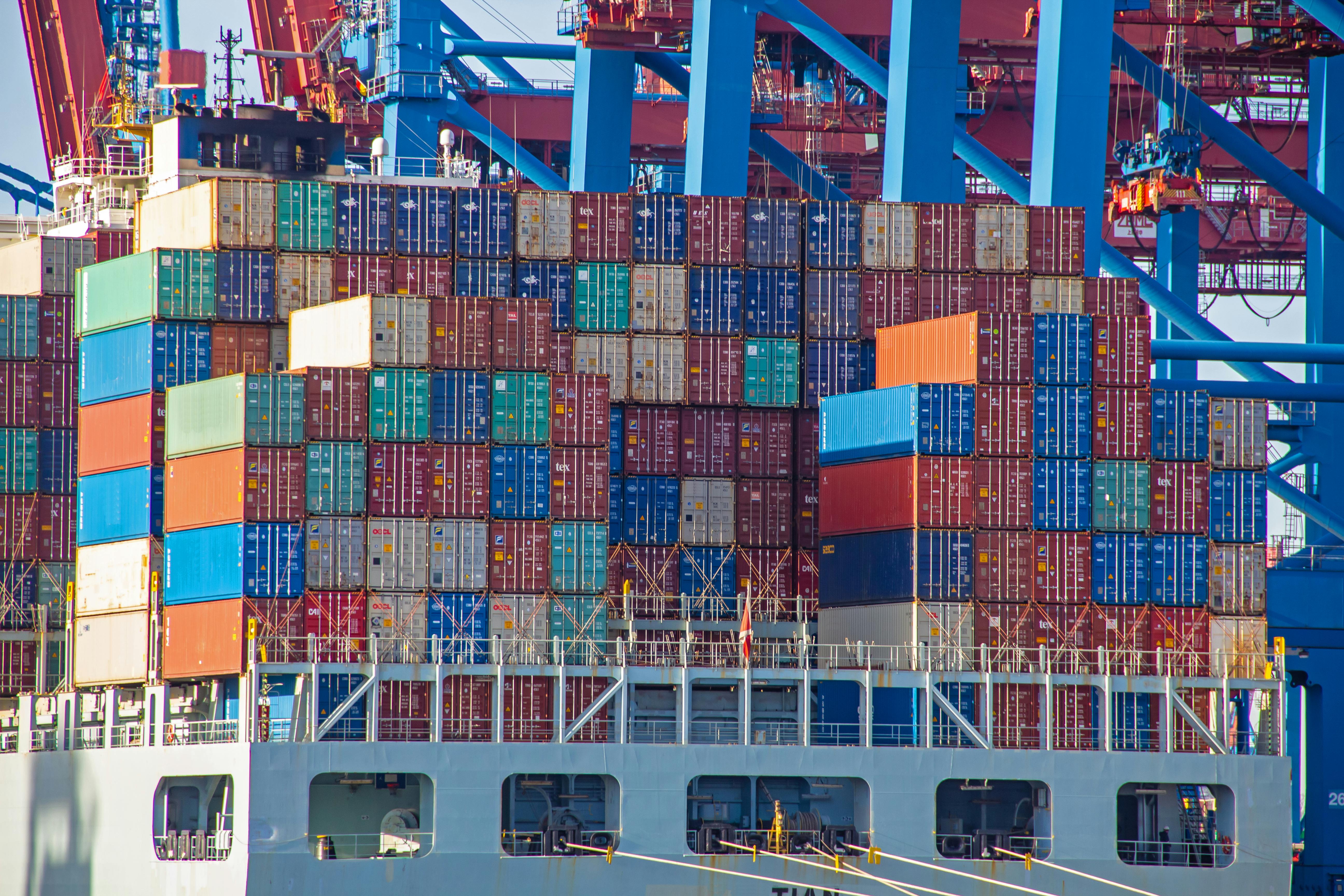 Container ship with colorful containers on the vessel quayside in the freight terminal of the harbor