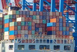 Container ship with colorful containers on the vessel quayside in the freight terminal of the harbor Container ship with colorful containers on the vessel quayside in the freight terminal of the harbor