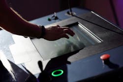 Operator working with HMI touch screen panel Operator working with HMI touch screen panel