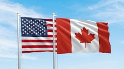 United States and Canada flags, two flags waving on sky background United States and Canada flags, two flags waving on sky background