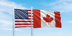 United States and Canada flags, two flags waving on sky background United States and Canada flags, two flags waving on sky background