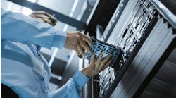 Low Angle Shot In Fully Working Data Center IT Engineer Installs Hard Drive into Server Rack Low Angle Shot In Fully Working Data Center IT Engineer Installs Hard Drive into Server Rack