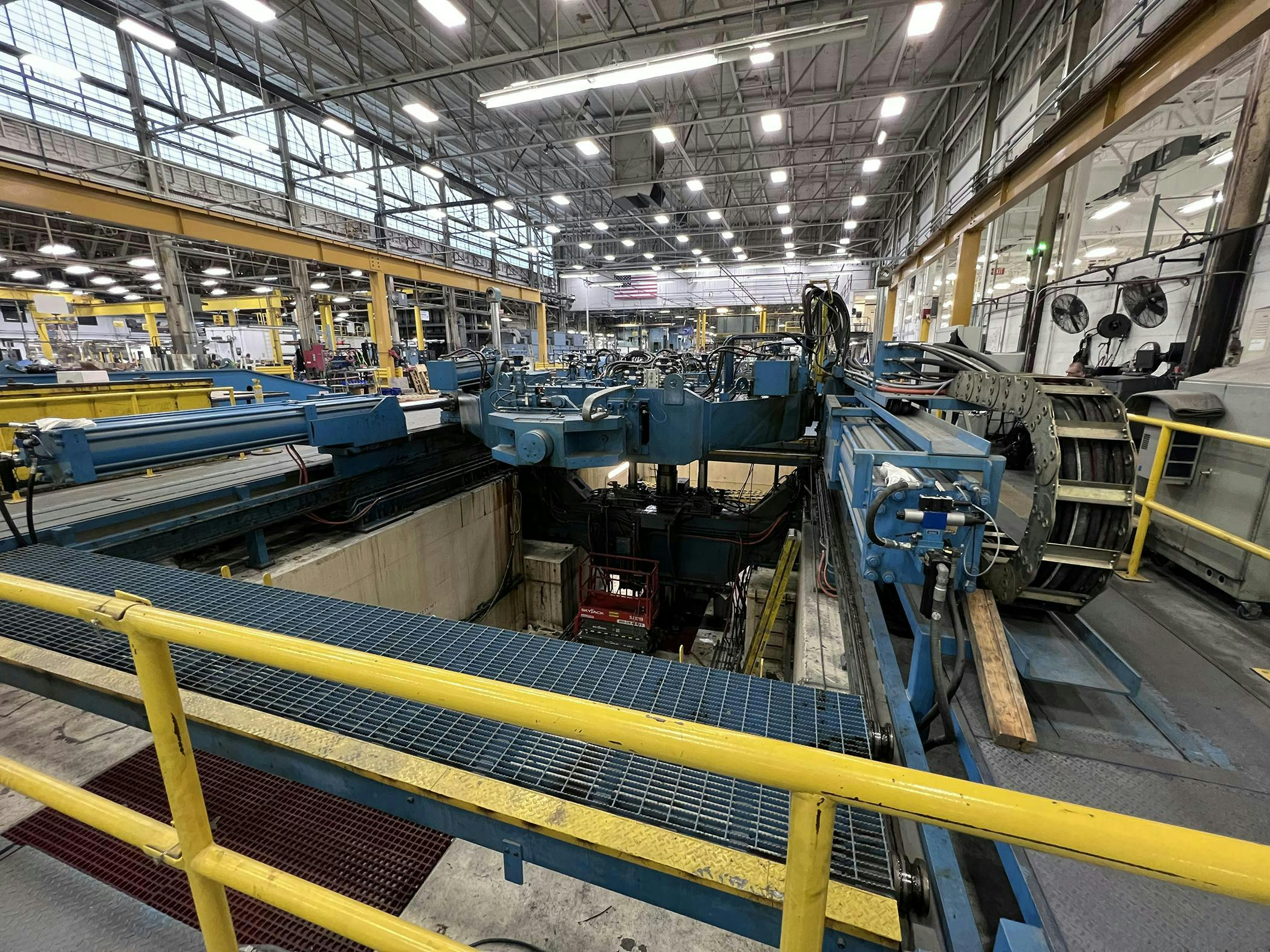 Figure 1: The stretch forming press is almost the size of an Olympic-size swimming pool and more than twice as deep. Figure 1: The stretch forming press is almost the size of an Olympic-size swimming pool and more than twice as deep.