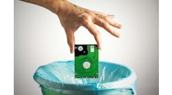 Person's hand throws a computer hard disk into the trash bin Person's hand throws a computer hard disk into the trash bin