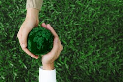 Two hands holding green earth together on nature background for the Sustainable Development Goals Two hands holding green earth together on nature background for the Sustainable Development Goals