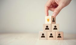 Hand flips cube with icon light bulb and human symbol Hand flips cube with icon light bulb and human symbol