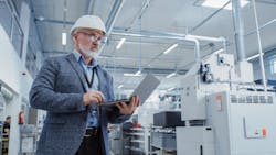 Heavy Industry Specialist Working on Laptop Computer. Heavy Industry Specialist Working on Laptop Computer.