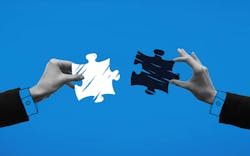 Hands holding puzzle pieces and trying to connect it against blue background. Hands holding puzzle pieces and trying to connect it against blue background.