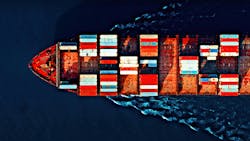 Aerial view of a cargo ship carrying colorful containers, cutting through deep blue waters with visible wave patterns. Aerial view of a cargo ship carrying colorful containers, cutting through deep blue waters with visible wave patterns.