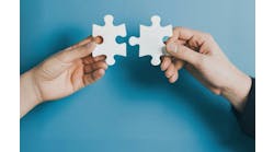 Hands bringing puzzle pieces together Hands bringing puzzle pieces together