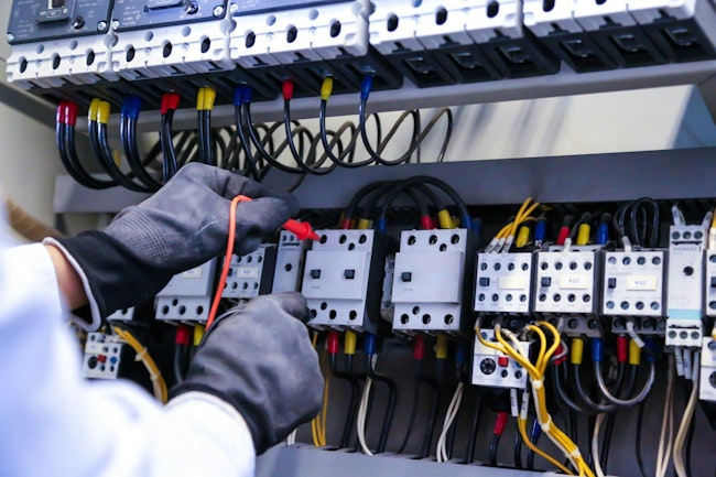 Electricity and electrical maintenance service, Engineer checking electric at circuit breaker and cable wiring system for repairing main power distribution board.