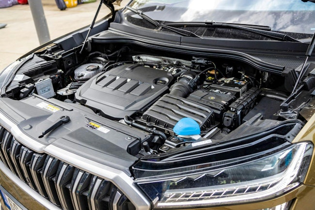 A view of the engine compartment of a modern brown combustion SUV with a large spacious body
