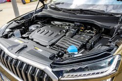 A view of the engine compartment of a modern brown combustion SUV with a large spacious body A view of the engine compartment of a modern brown combustion SUV with a large spacious body