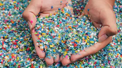 Cupped handfuls of multi-colored plastic pieces