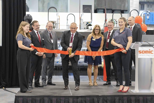 On stage for the ribbon cutting ceremony were (from left) Peter Fox, Somic Packaging CEO; James Schollett, president of the German American Chamber of Commerce Minnesota chapter; Patrick Bonetsmuller, Somic chairman; Brenda Dietrich, mayor of Inver Grove Heights; Dr. Gerhard Huber, CEO of Somic Group; and Tim Haase, COO of Somic Group.