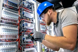 Electrician in switchboard room. Cable installation. Wiring work. Electrician in switchboard room. Cable installation. Wiring work.