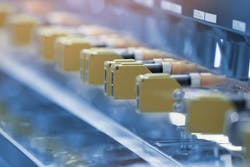 Photoelectric Sensor installed in a row of industrial machine in a factory. Photo sensor for object detection in machine factory. Photoelectric Sensor installed in a row of industrial machine in a factory. Photo sensor for object detection in machine factory.