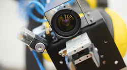 Machine vision. The robot is staring at the viewer. The manipulator arm uses a camera to observe and control objects and communication with a person.