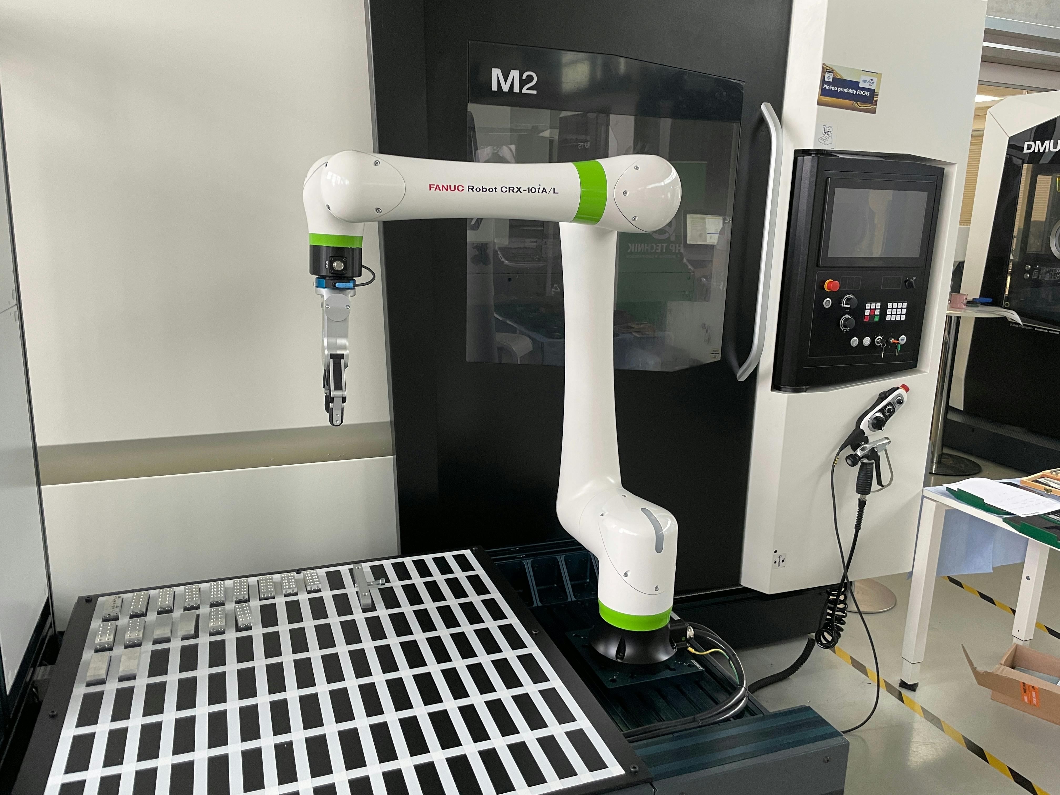 Collaborative robot (Cobot) from FANUC producer as part of production cell in show room of DMG MORI SEIKI machine tools builder in Brno in the Czech Republic.