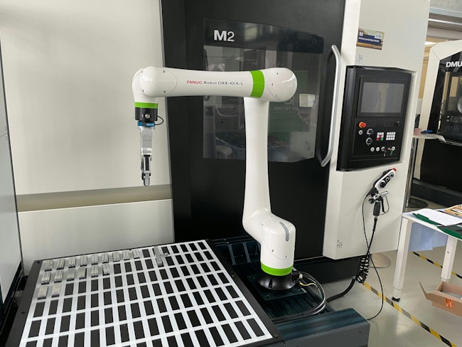 Collaborative robot (Cobot) from FANUC producer as part of production cell in show room of DMG MORI SEIKI machine tools builder in Brno in the Czech Republic.