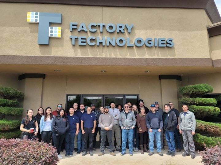 Factory Technologies group photo in front of the company building
