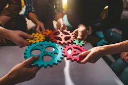 Teamwork of business people work together and combine pieces of gears Teamwork of business people work together and combine pieces of gears