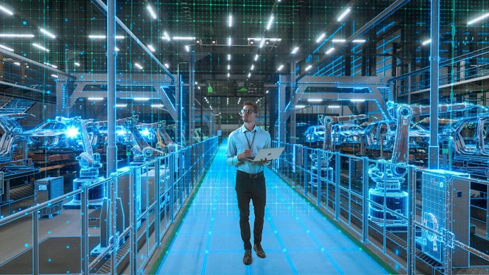 Engineer With Laptop Activates Autonomous EV Factory Digitization. Visualization Shows Robotic Arms, Assembly Line, Digital Twin Lines of Data, Computer Vision Transformation Manufacturing Technology