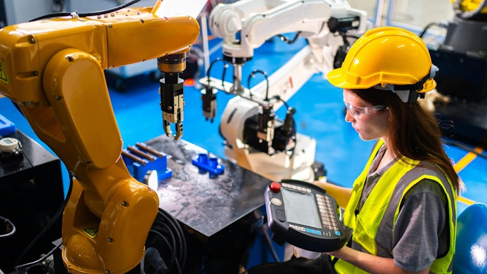 Professional and intelligence female engineer used her technical hard skill to fix, repair or maintenance machine robotic arm in factory or industrial, examining or welding automobile machine workshop