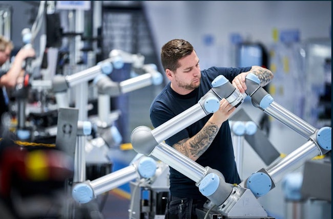 An engineer working on a collaborative robot in a Teradyne Robotics factory.