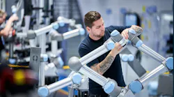 An engineer working on a collaborative robot in a Teradyne Robotics factory.